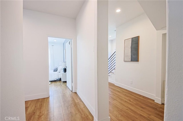 hall with hardwood / wood-style floors