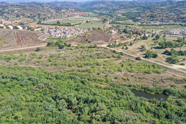 birds eye view of property featuring a water and mountain view