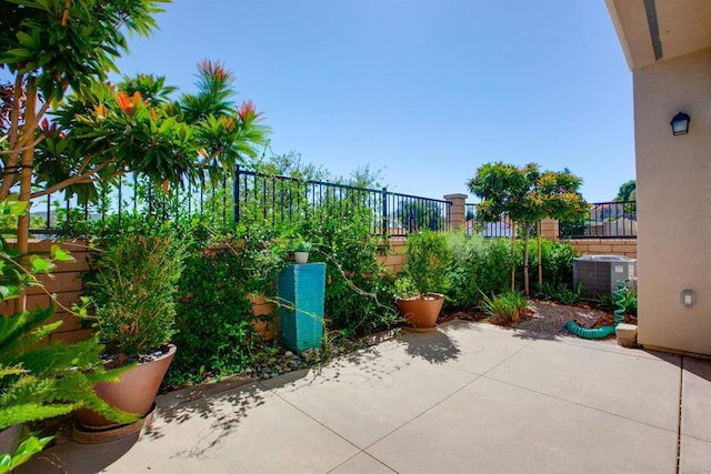 view of patio / terrace with a fenced backyard and central air condition unit