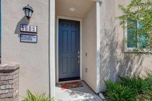 doorway to property with stucco siding