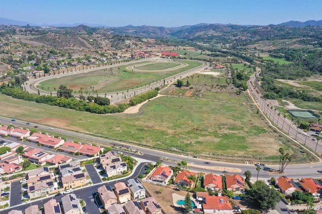 drone / aerial view featuring a residential view and a mountain view