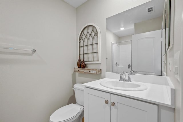 bathroom featuring a stall shower, visible vents, vanity, and toilet