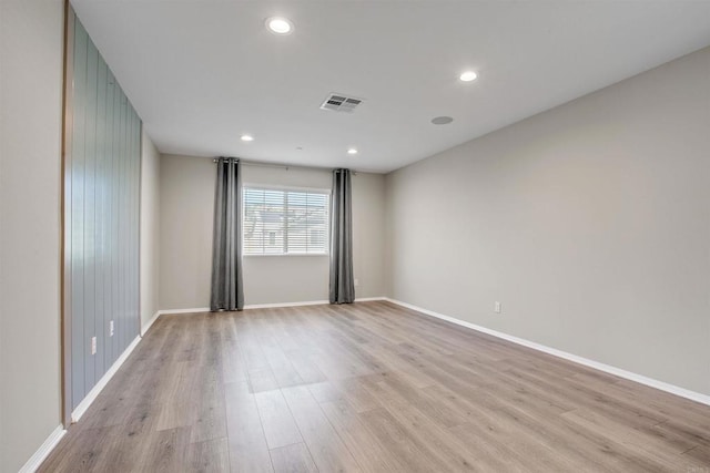 spare room with recessed lighting, light wood-type flooring, visible vents, and baseboards