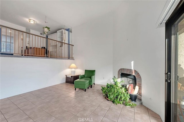 living area featuring light tile patterned flooring and a fireplace