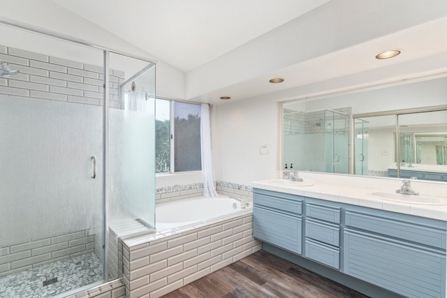 bathroom featuring vanity, shower with separate bathtub, vaulted ceiling, and hardwood / wood-style floors