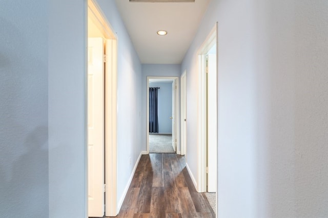 hallway with baseboards, recessed lighting, and dark wood-style flooring