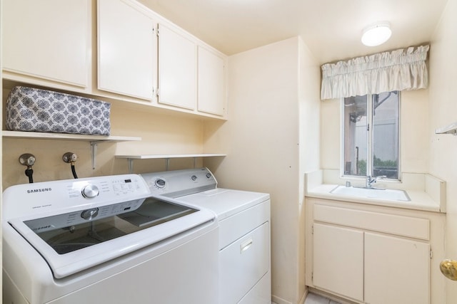 laundry room featuring sink, cabinets, and washer and dryer