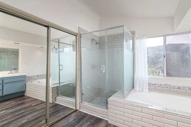 bathroom featuring lofted ceiling, plus walk in shower, hardwood / wood-style floors, and vanity