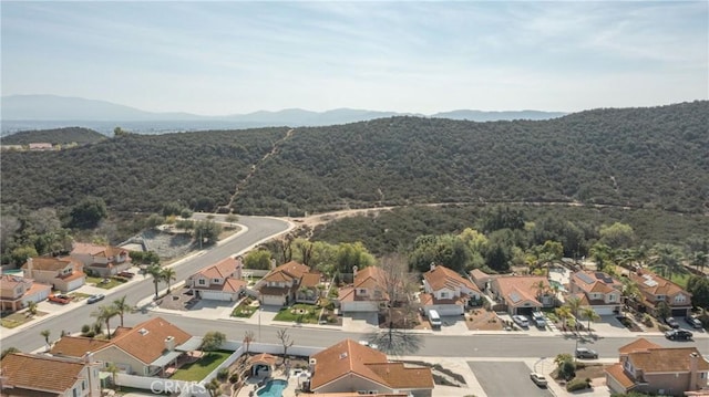 aerial view featuring a residential view, a mountain view, and a forest view