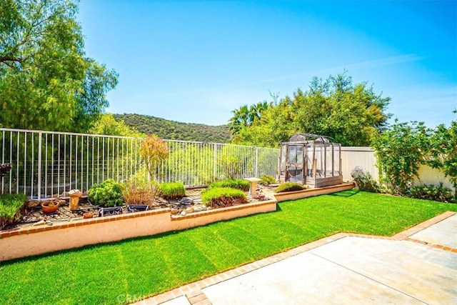 view of yard with a fenced backyard, a patio area, and a vegetable garden