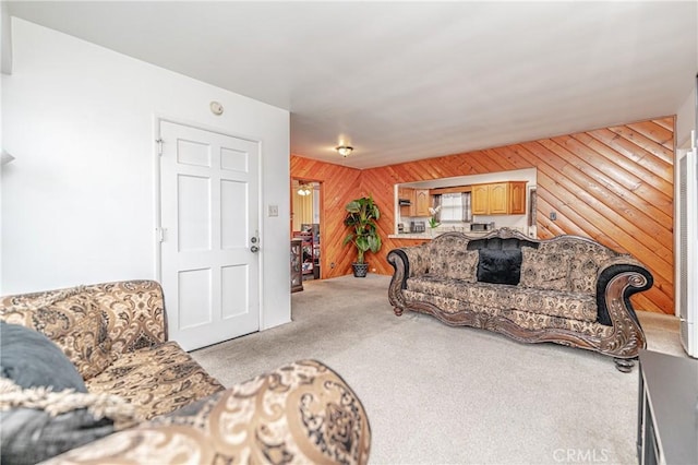 living room featuring light colored carpet and wood walls