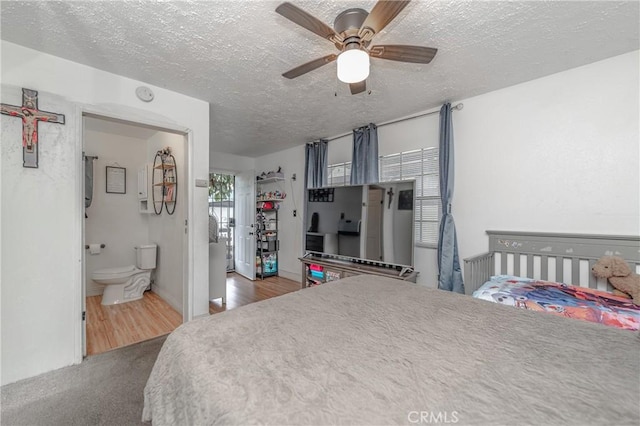 bedroom featuring ceiling fan, carpet, and a textured ceiling