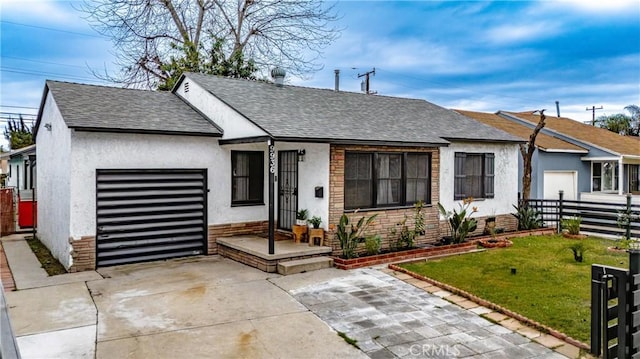 single story home with a garage and a front yard