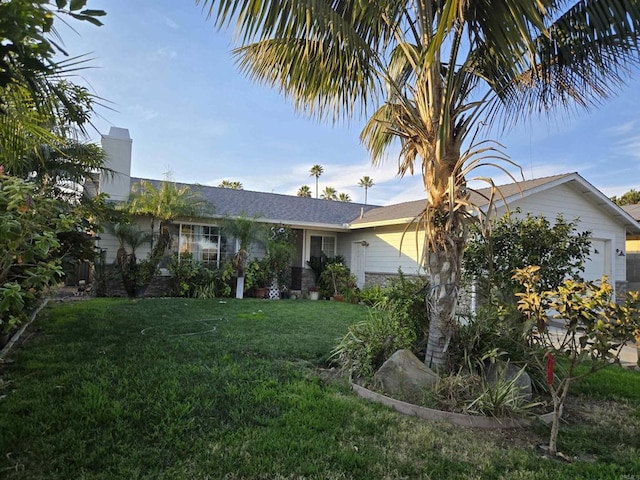 view of front facade featuring a chimney and a front yard