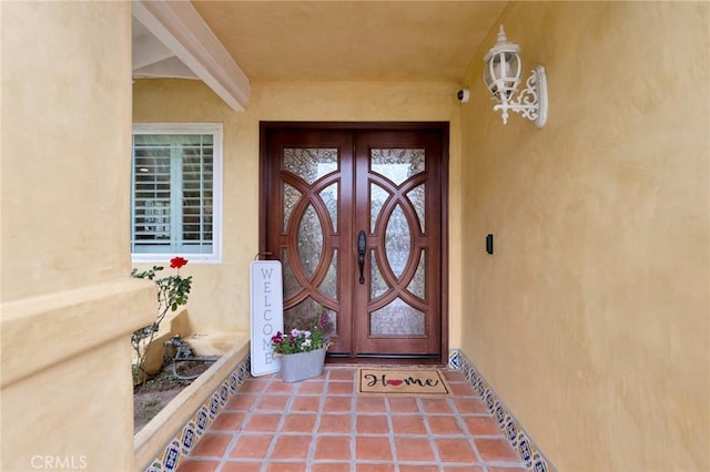 entrance to property with stucco siding