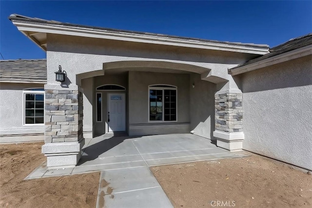 doorway to property with a patio area