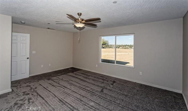 carpeted spare room with ceiling fan and a textured ceiling