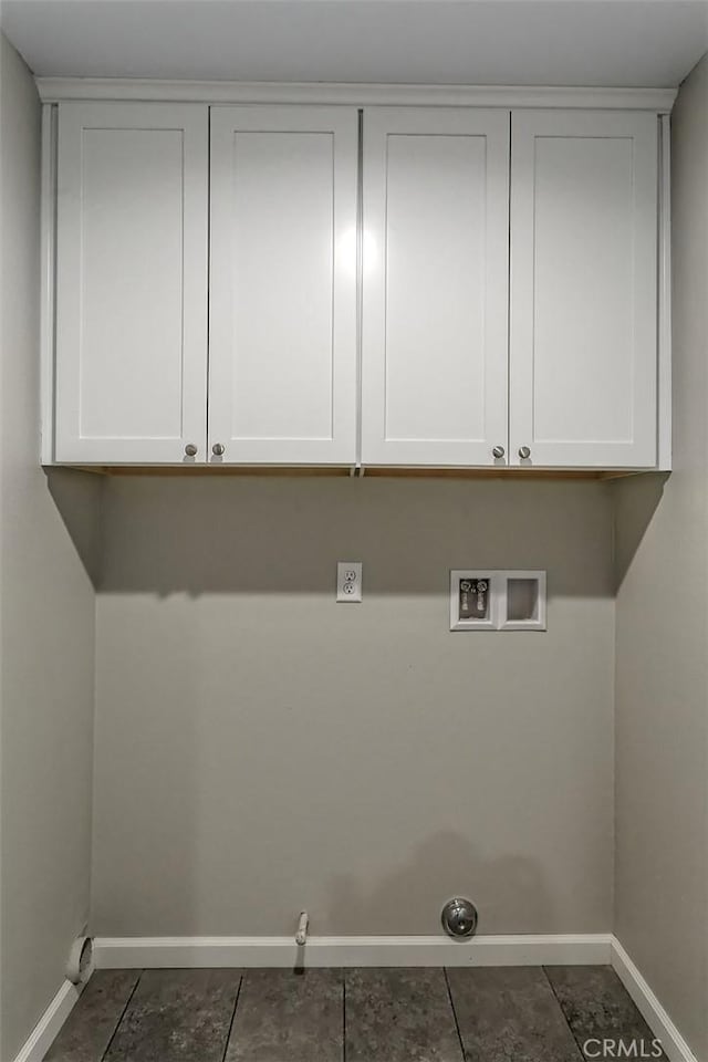 laundry area with gas dryer hookup, cabinets, washer hookup, and dark tile patterned floors