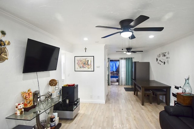 living room featuring ornamental molding and light wood-type flooring