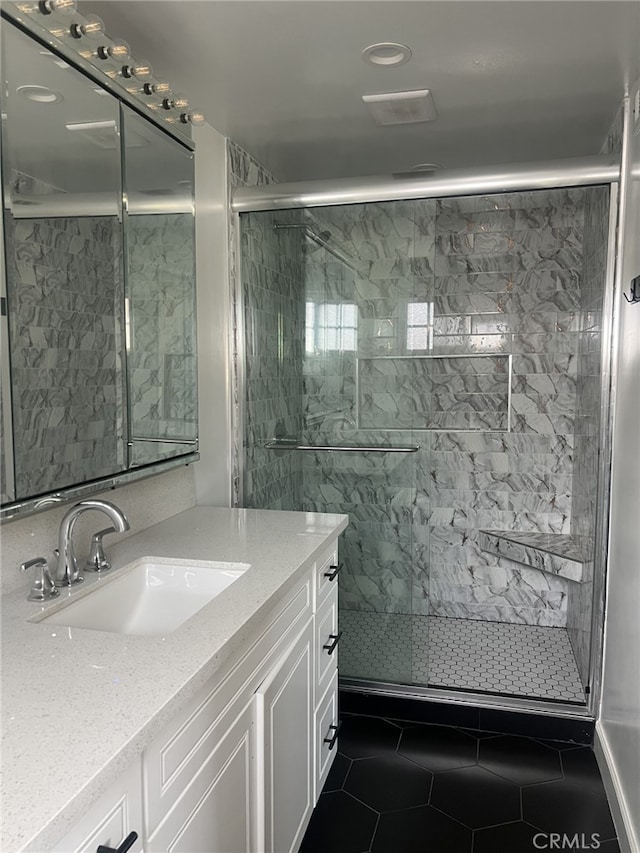 bathroom featuring tile patterned floors, vanity, and walk in shower