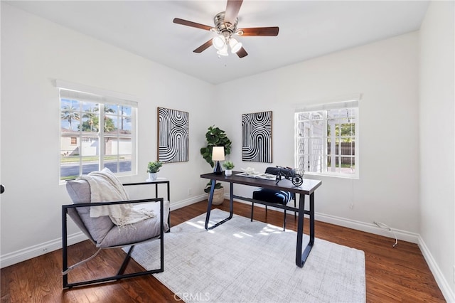 office area featuring baseboards, dark wood-type flooring, and a ceiling fan