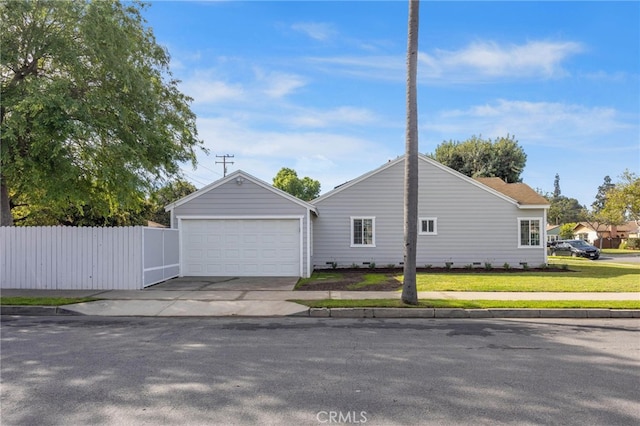 view of home's exterior featuring an attached garage, fence, a yard, and driveway