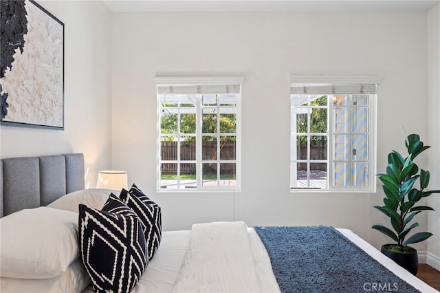 bedroom with baseboards and wood finished floors