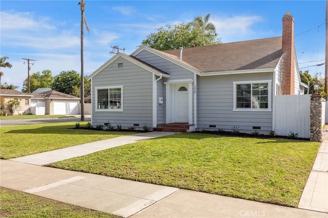 view of front of home featuring a shingled roof, a front lawn, fence, a chimney, and crawl space