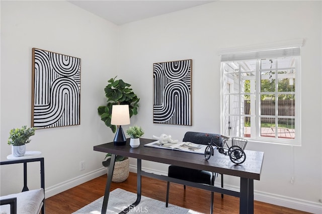 office space with baseboards and wood finished floors