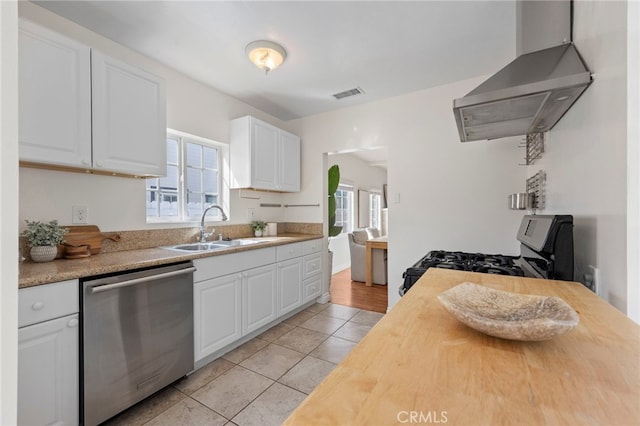 kitchen featuring visible vents, a sink, stainless steel dishwasher, gas range, and wall chimney exhaust hood