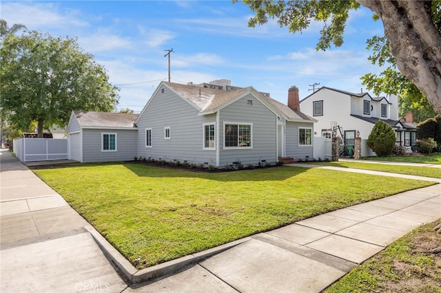 view of front of property with a front lawn and fence