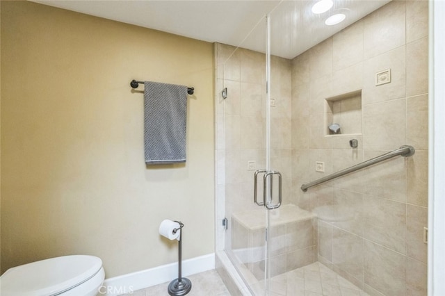 bathroom with walk in shower, tile patterned floors, and toilet