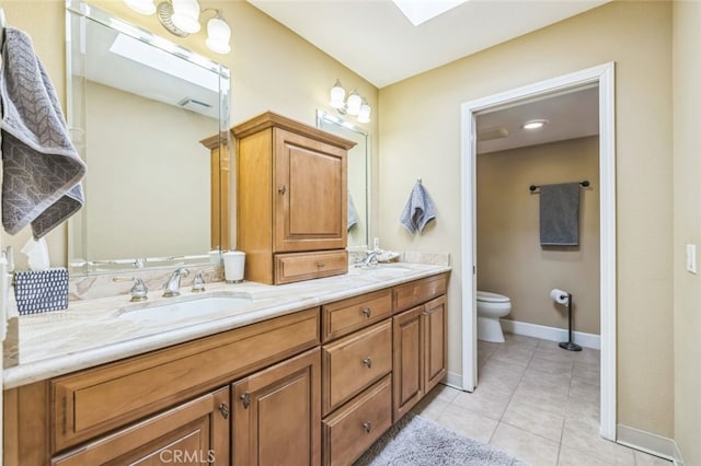 bathroom featuring tile patterned floors, toilet, and vanity