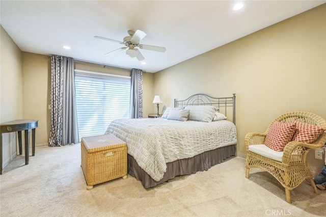 bedroom featuring light colored carpet and ceiling fan