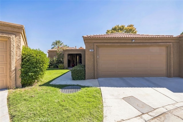 view of front facade featuring driveway, a garage, stucco siding, a tiled roof, and a front yard