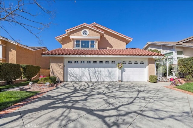 mediterranean / spanish-style home with fence, a tile roof, concrete driveway, stucco siding, and an attached garage