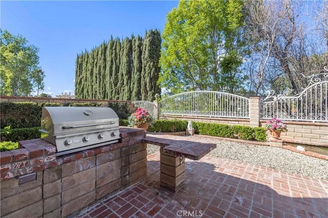 view of patio with a grill, exterior kitchen, and fence