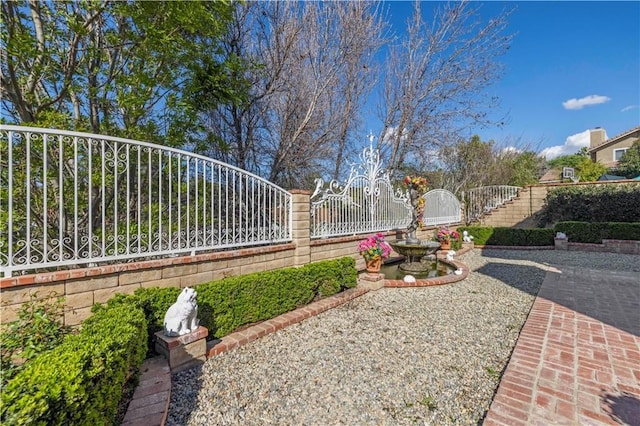 view of yard with fence and a gate