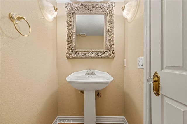 bathroom featuring a textured wall