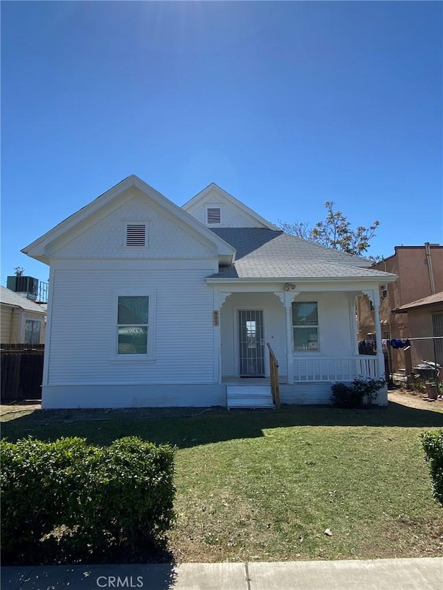 view of front of property with a porch and a front lawn