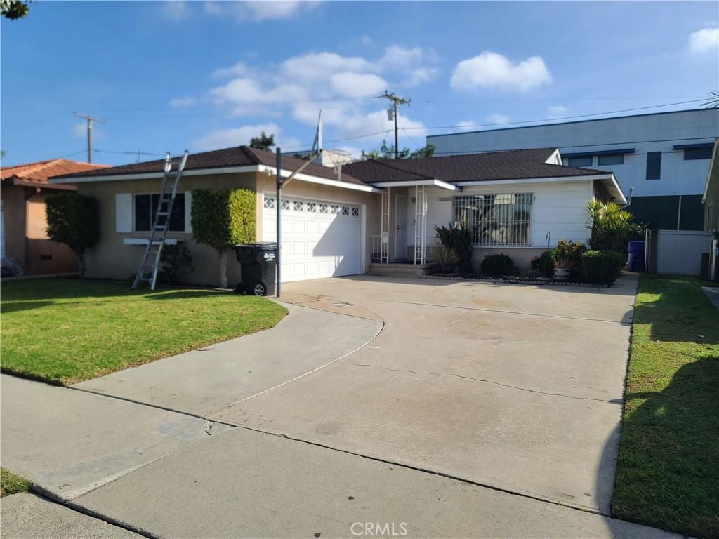 ranch-style house featuring a garage and a front yard