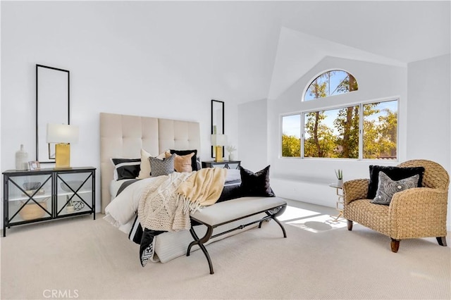 bedroom featuring high vaulted ceiling and carpet flooring