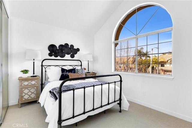 bedroom featuring carpet, vaulted ceiling, and baseboards