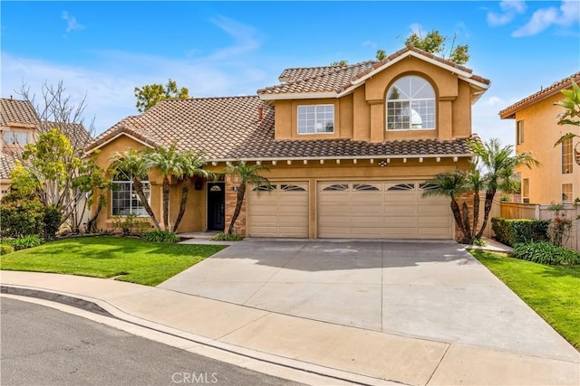 view of front of house featuring stucco siding, concrete driveway, a front yard, fence, and a tiled roof