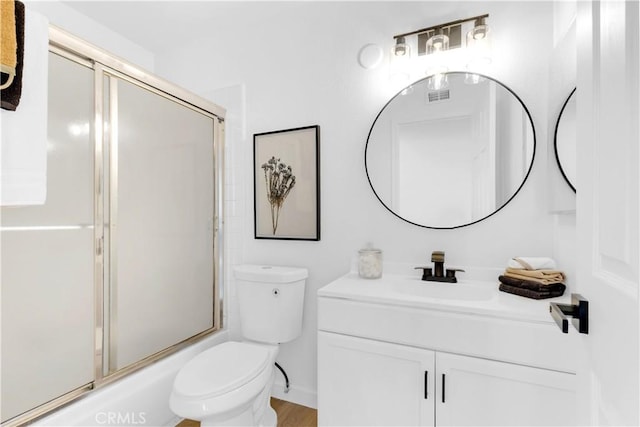 bathroom with toilet, visible vents, bath / shower combo with glass door, and vanity