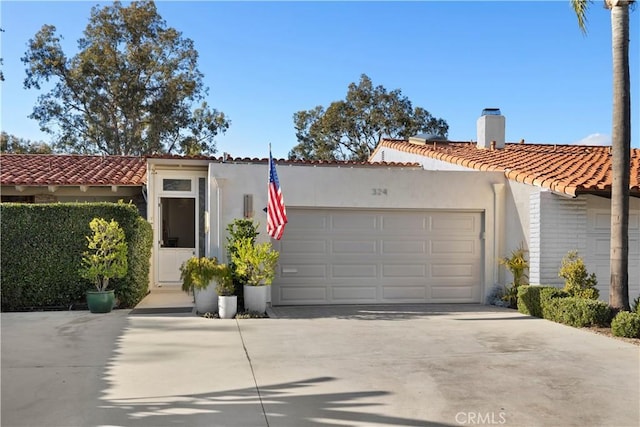 mediterranean / spanish-style house with a garage