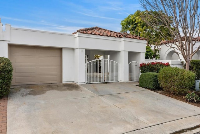 mediterranean / spanish house with a garage