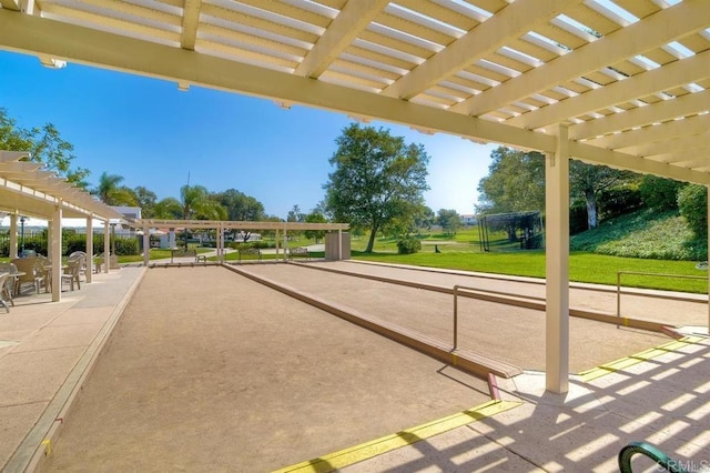 view of home's community with a pergola and a lawn