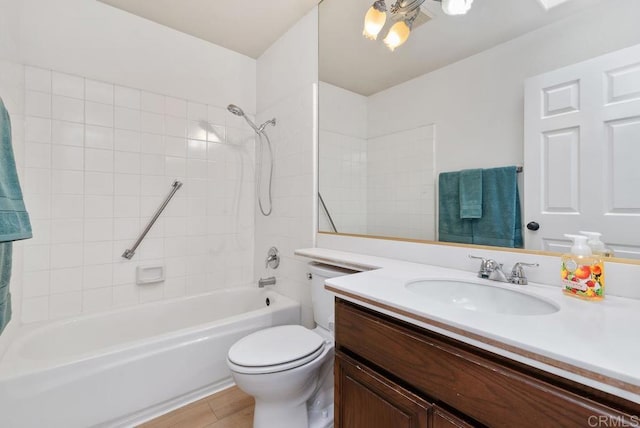 full bathroom featuring vanity, toilet, and tiled shower / bath combo