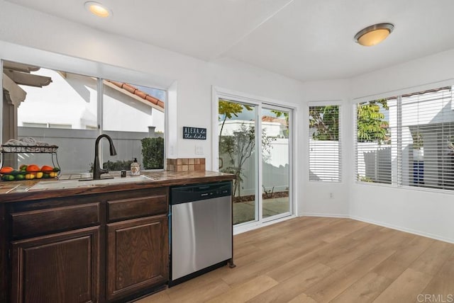 kitchen featuring sink, dark brown cabinets, light hardwood / wood-style flooring, and stainless steel dishwasher